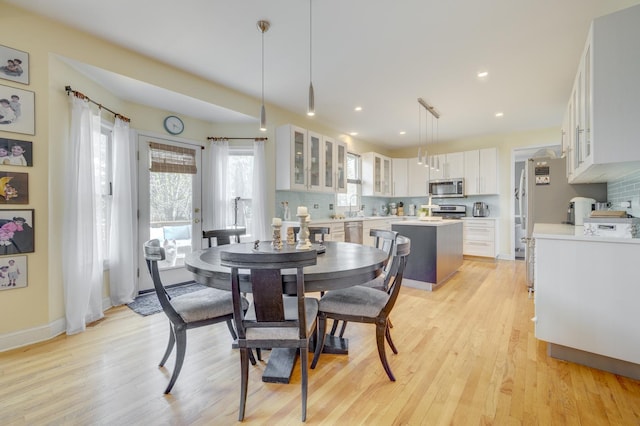 dining area with light wood-style floors, baseboards, and recessed lighting