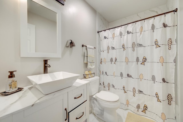 full bathroom with vanity, toilet, and curtained shower
