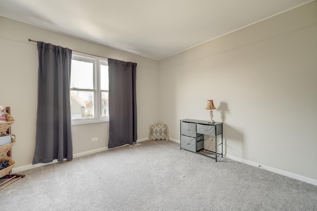 carpeted spare room with baseboards