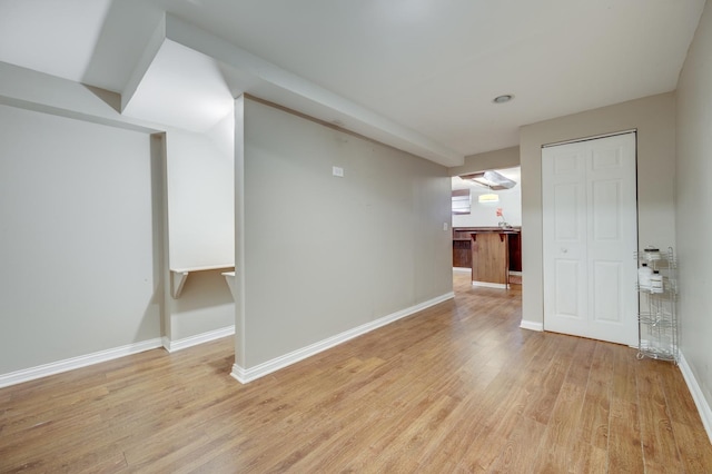unfurnished room with baseboards and light wood finished floors