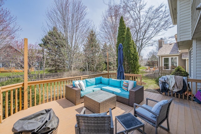 wooden deck with an outdoor living space and a fenced backyard