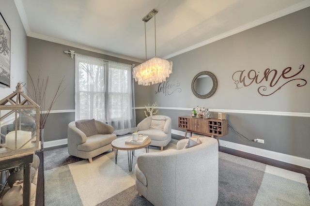 sitting room with baseboards, a notable chandelier, and ornamental molding