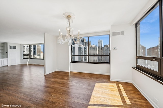 1410 N State Pkwy Unit 17B, Chicago, IL 60610 - unfurnished room with a skyline view, a chandelier, and wood finished floors