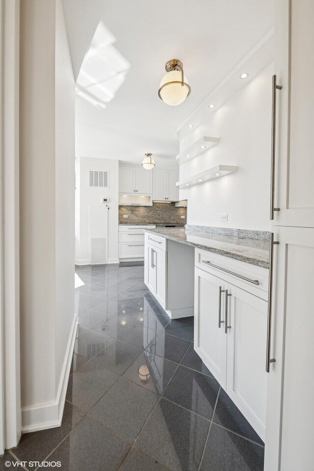 1410 N State Pkwy Unit 17B, Chicago, IL 60610 - kitchen featuring granite tiled floors, recessed lighting, white cabinets, tasteful backsplash, and open shelves