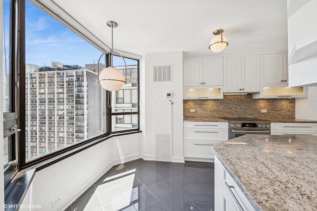 1410 N State Pkwy Unit 17B, Chicago, IL 60610 - kitchen with wall oven, decorative backsplash, light stone counters, white cabinetry, and granite tiled floors