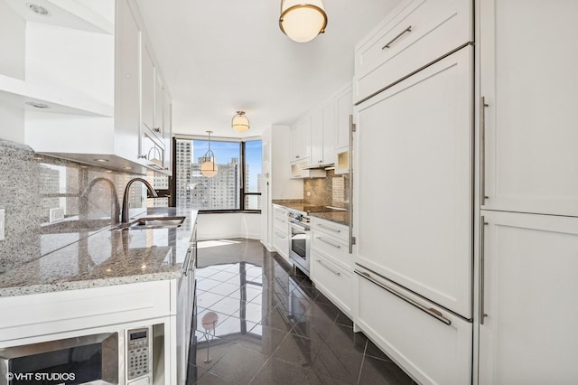 1410 N State Pkwy Unit 17B, Chicago, IL 60610 - kitchen featuring tasteful backsplash, white cabinetry, appliances with stainless steel finishes, and granite tiled floors