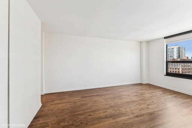 1410 N State Pkwy Unit 17B, Chicago, IL 60610 - spare room featuring wood finished floors and a city view