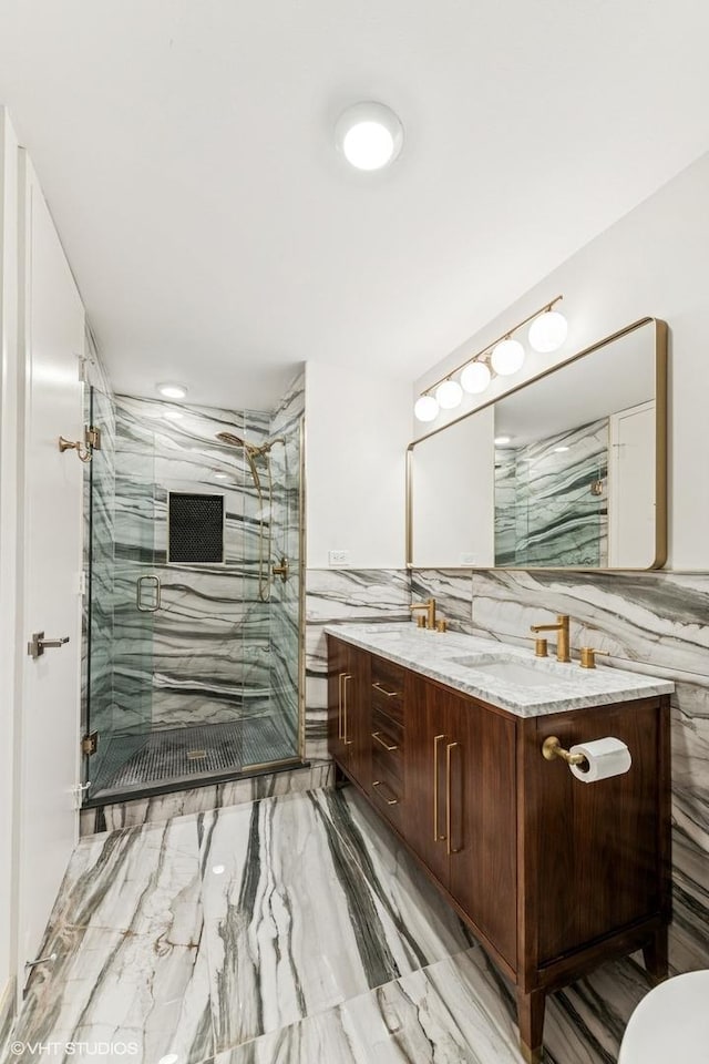 1410 N State Pkwy Unit 17B, Chicago, IL 60610 - full bathroom with marble finish floors, double vanity, a shower stall, and tile walls