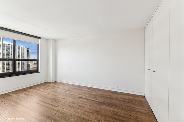 1410 N State Pkwy Unit 17B, Chicago, IL 60610 - unfurnished room featuring wood finished floors and a view of city