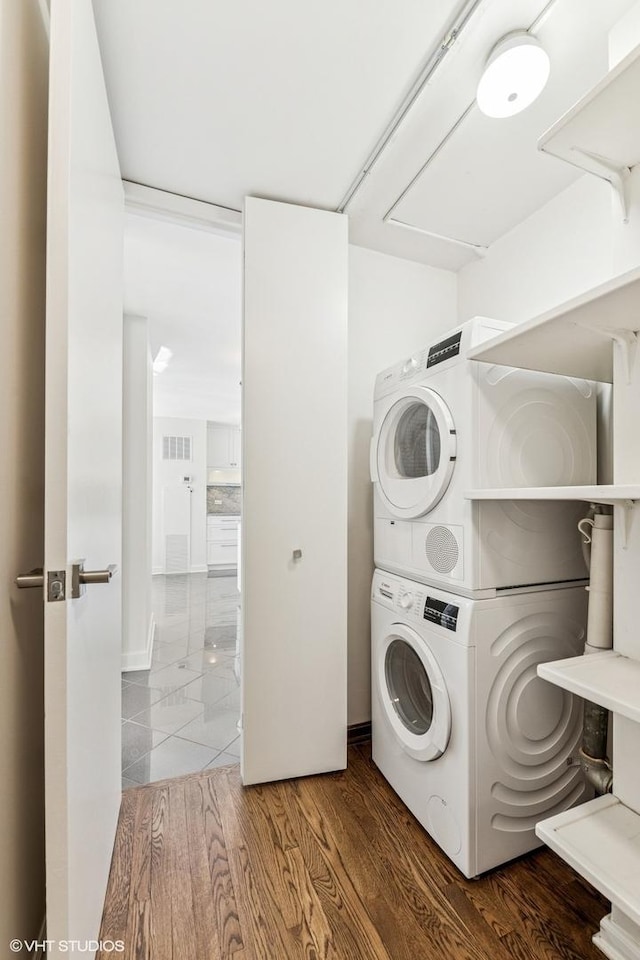 1410 N State Pkwy Unit 17B, Chicago, IL 60610 - laundry room featuring stacked washer / dryer and wood finished floors