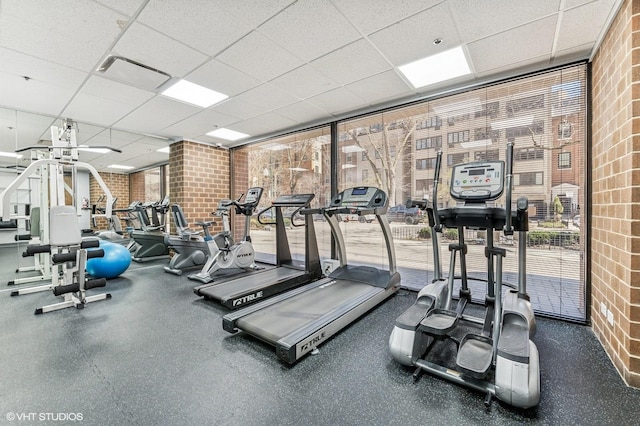 1410 N State Pkwy Unit 17B, Chicago, IL 60610 - workout area with brick wall, a drop ceiling, floor to ceiling windows, and healthy amount of natural light