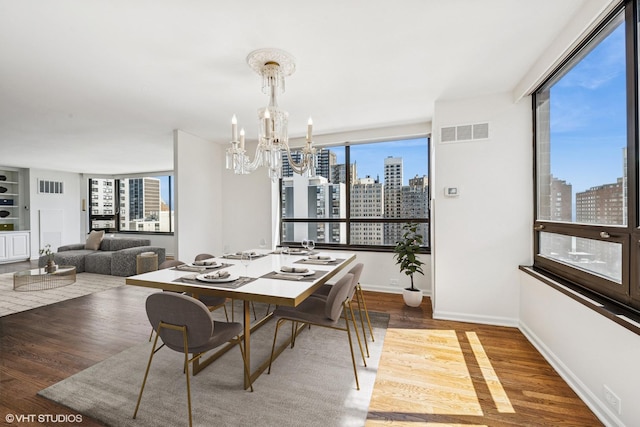 1410 N State Pkwy Unit 17B, Chicago, IL 60610 - dining space with a skyline view, wood finished floors, and a chandelier