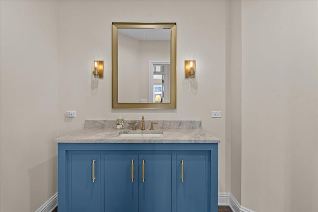bathroom featuring baseboards and vanity