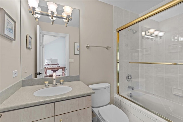 bathroom with an inviting chandelier, vanity, tiled shower / bath, and toilet