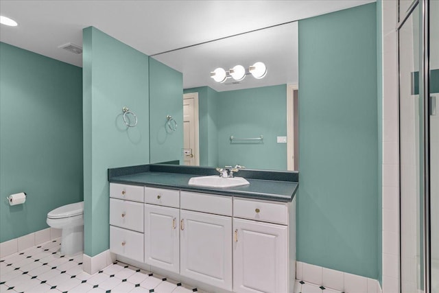bathroom with visible vents, a stall shower, vanity, baseboards, and toilet