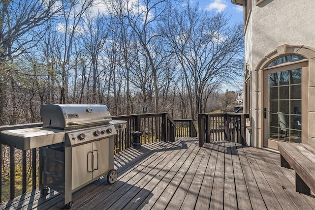 wooden terrace featuring area for grilling