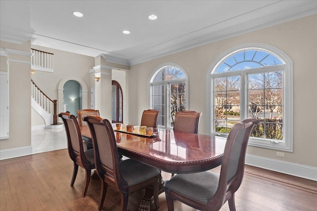 dining space with ornate columns, baseboards, recessed lighting, and wood finished floors