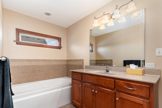 bathroom with a garden tub and vanity