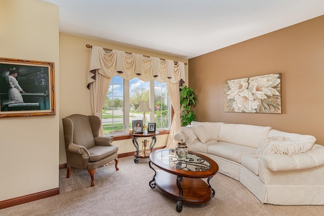 carpeted living area with baseboards