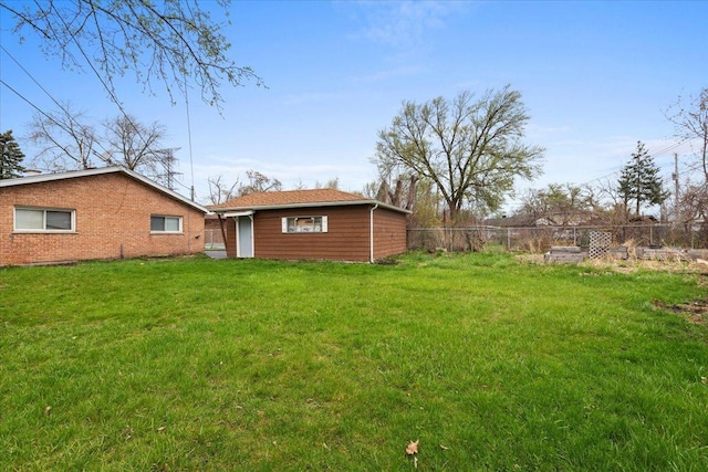 1303 Balmoral Ave, Calumet City, IL 60409 - rear view of property with a yard and fence