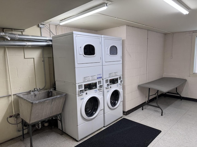 660 Washington Blvd Unit 5, Oak Park, IL 60302 - shared laundry room featuring stacked washing machine and dryer, concrete block wall, light flooring, and independent washer and dryer
