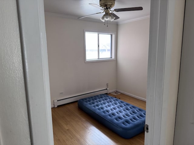 660 Washington Blvd Unit 5, Oak Park, IL 60302 - bedroom with a baseboard radiator, crown molding, wood finished floors, baseboards, and ceiling fan