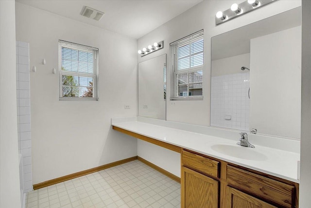1123 Coneflower Ct, Minooka, IL 60447 - bathroom with a shower, vanity, and baseboards