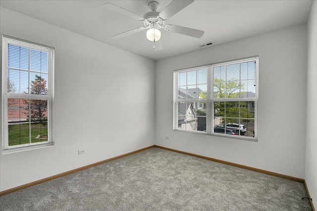 1123 Coneflower Ct, Minooka, IL 60447 - empty room with carpet, plenty of natural light, baseboards, and a ceiling fan