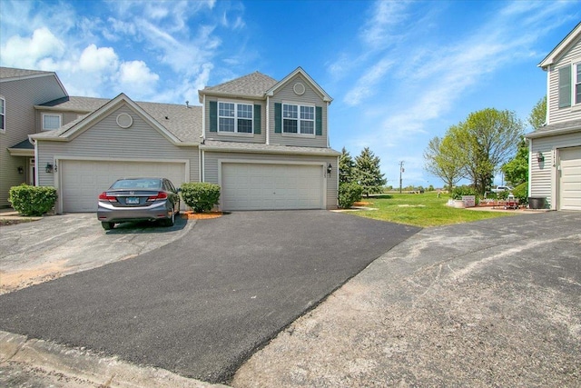 1123 Coneflower Ct, Minooka, IL 60447 - view of front facade with asphalt driveway, a front yard, and roof with shingles