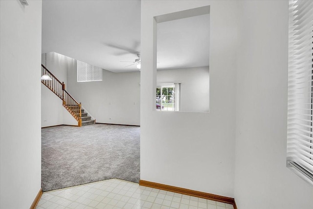 1123 Coneflower Ct, Minooka, IL 60447 - carpeted spare room featuring ceiling fan, baseboards, and stairway