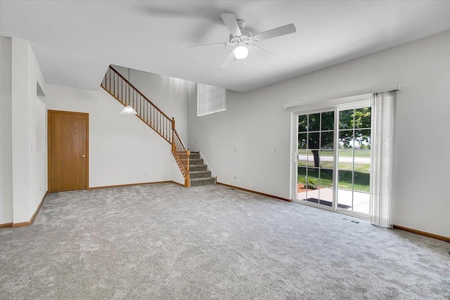 1123 Coneflower Ct, Minooka, IL 60447 - unfurnished living room featuring stairs, carpet flooring, baseboards, and ceiling fan