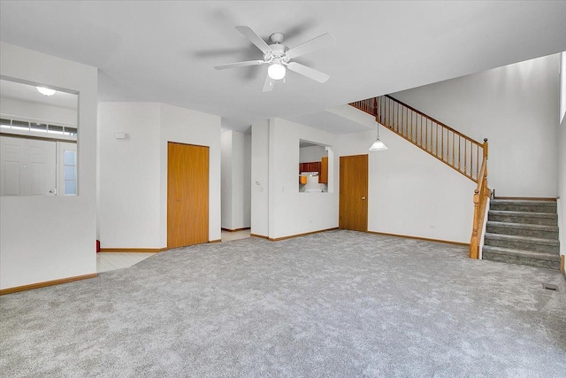 1123 Coneflower Ct, Minooka, IL 60447 - unfurnished living room featuring carpet, stairway, ceiling fan, and baseboards