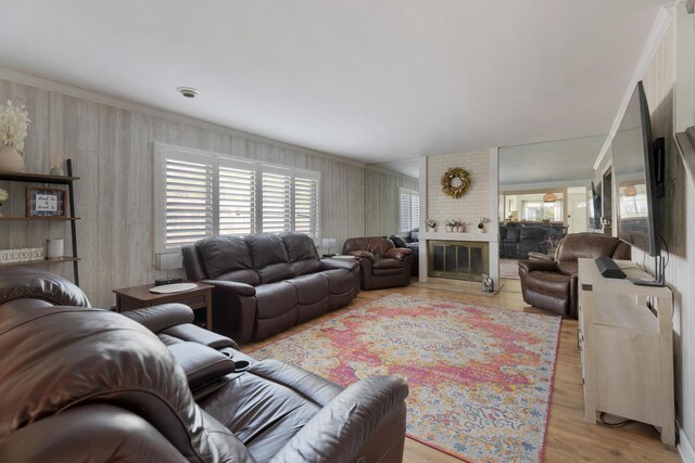 living room with crown molding and light wood-style floors
