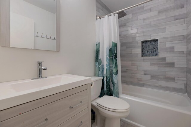 bathroom featuring toilet, shower / bath combo, and vanity