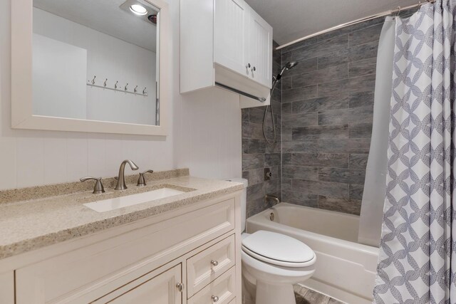 full bath featuring toilet, shower / bath combo, and vanity