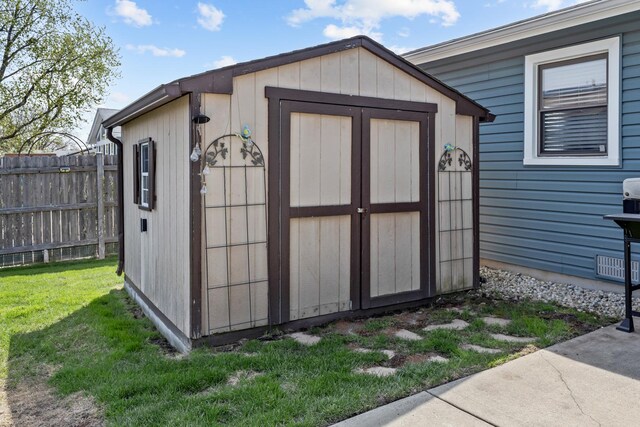view of shed featuring fence