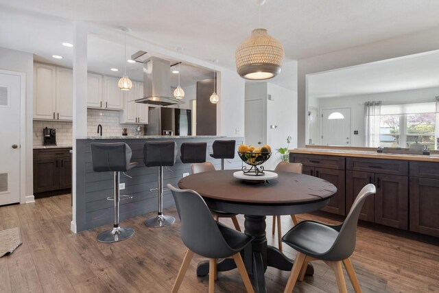 dining room featuring visible vents and wood finished floors