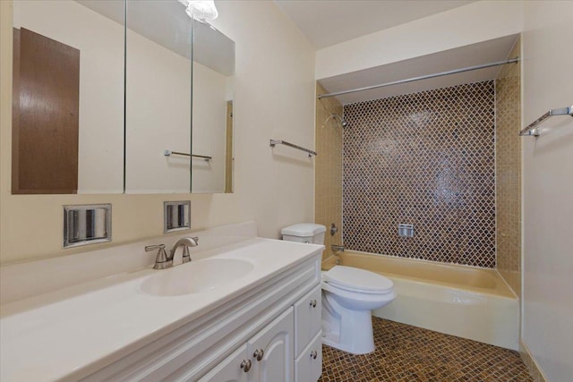 bathroom with toilet, tile patterned flooring, vanity, and shower / washtub combination
