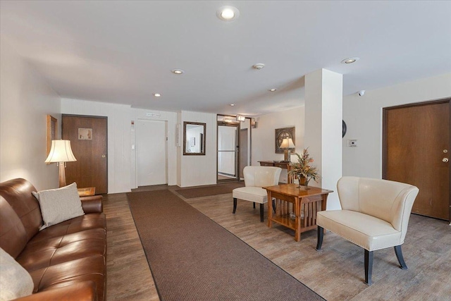 living area with recessed lighting and wood finished floors