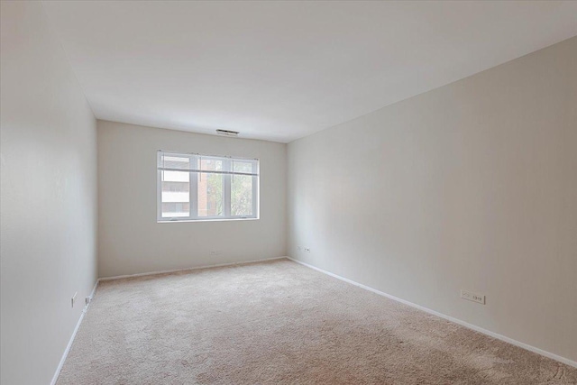 empty room featuring baseboards and carpet floors