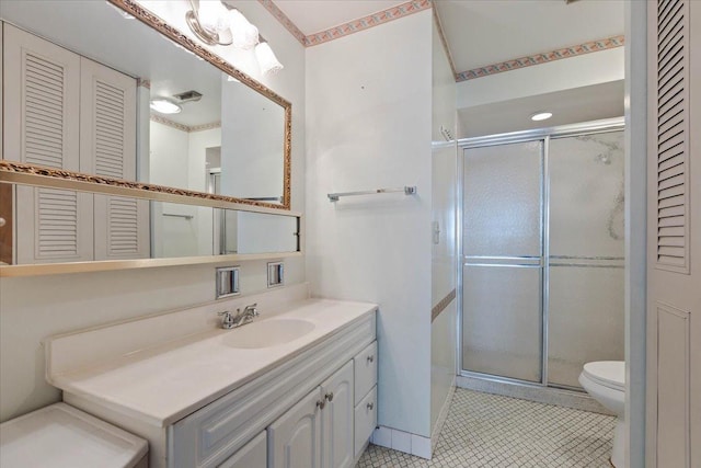 bathroom with toilet, a closet, and a shower stall