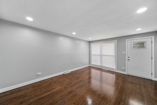 unfurnished living room with baseboards, visible vents, and recessed lighting