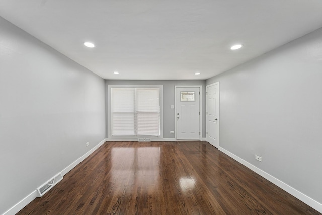 interior space with dark wood finished floors, visible vents, baseboards, and recessed lighting