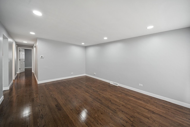 interior space featuring baseboards, recessed lighting, and dark wood-style floors