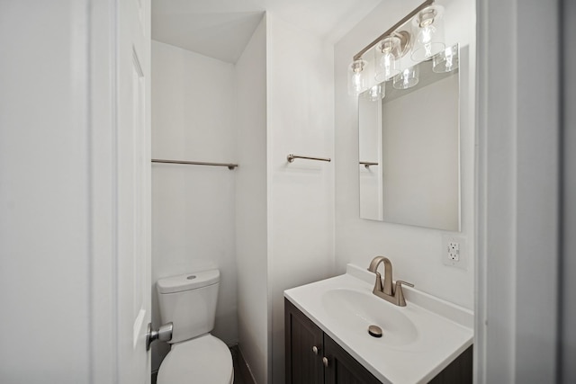 half bath featuring toilet and vanity
