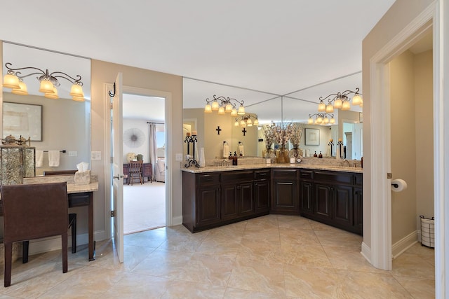 full bath with double vanity, tile patterned floors, and a sink