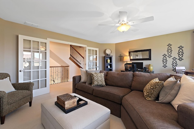living area featuring visible vents and a ceiling fan