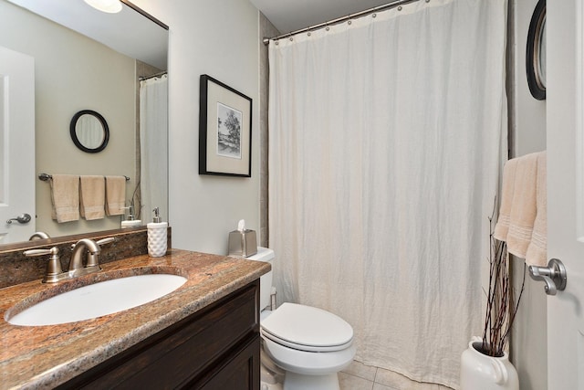 full bathroom with vanity, tile patterned floors, and toilet