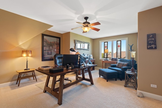 home office with a healthy amount of sunlight, baseboards, light carpet, and a ceiling fan