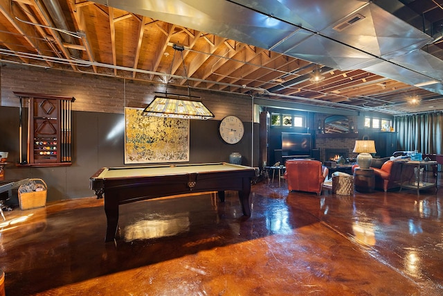 rec room with pool table, concrete flooring, a brick fireplace, and visible vents
